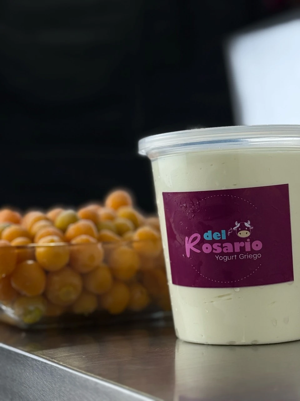 Yogur Del Rosario junto a un recipiente de uchuvas